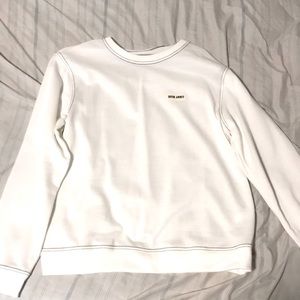 a white long sleeve sweater